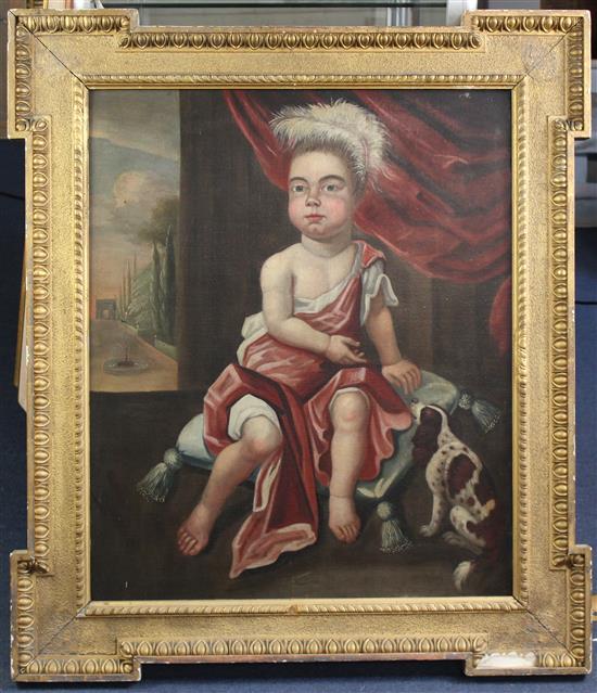 Early 18th century English School Portrait of a child seated upon a cushion with a spaniel, a garden vista beyond, 30 x 25in.